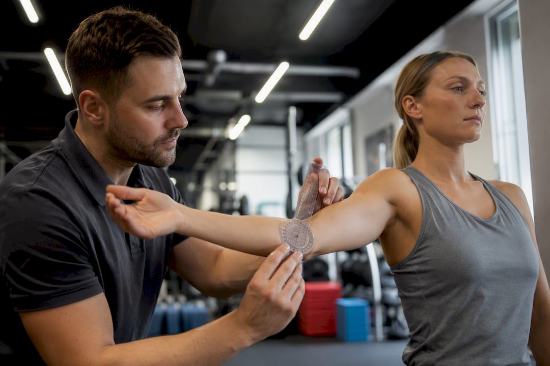 Chiropractor measuring patient’s range of motion