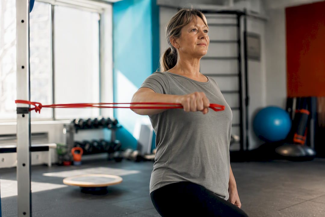 Woman doing rotator cuff resistance band exercise