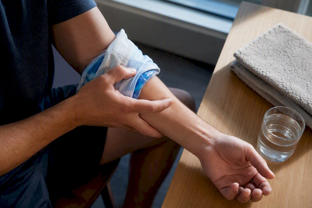 Cloth-wrapped ice pack on inner elbow